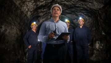 Engineer leading a group of miners